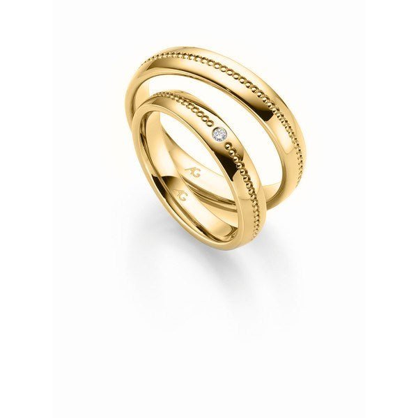 Flotte Gerstner vielsesringe i 9 eller 14 karat guld med hulmønster og 0,02 ct diamant – blanke og elegante fra Smykkecenter.