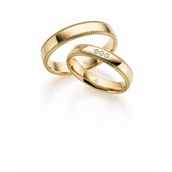 Eksklusiv Gerstner vielsesringe i 14 karat guld med elegant hulmønster og 0,03 ct diamanter fra Smykkecenter.