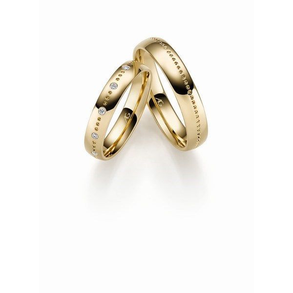 Raffinerede Gerstner vielsesringe i 14 eller 9 karat guld med hulmønster og 0,05 ct diamanter – blank overflade.