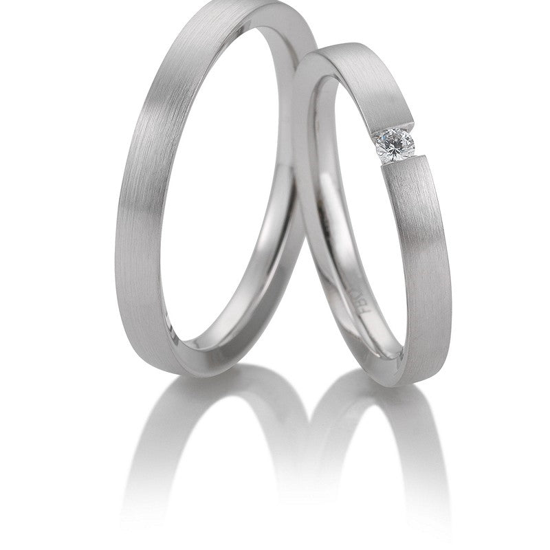 Eksklusive Breuning vielsesringe i 9 eller 14 karat hvidguld med let mat overflade og 0,05 ct diamant i damering – 3 mm brede.