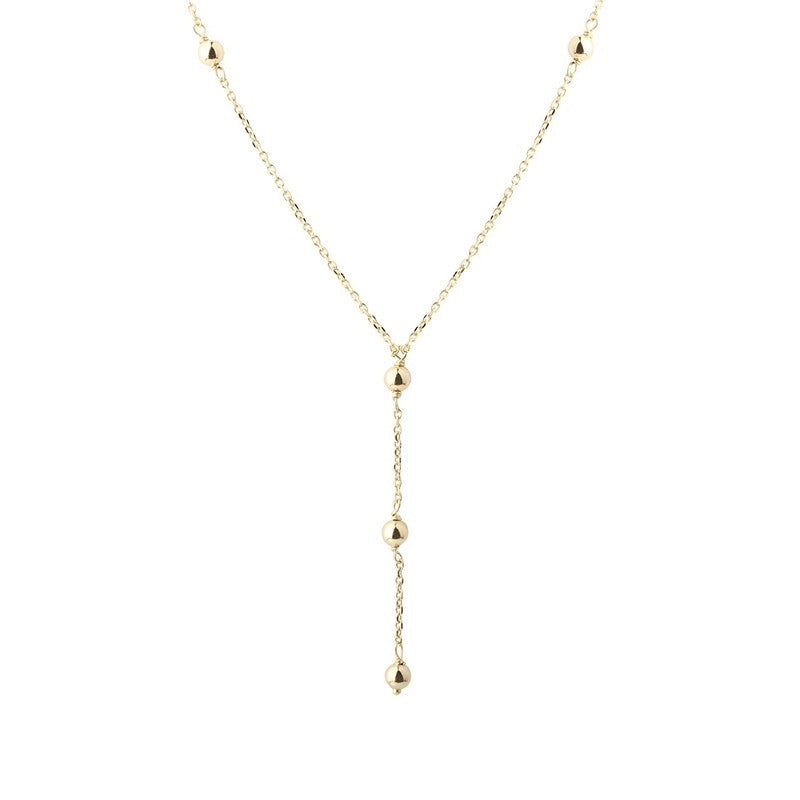 Lunella Ball Y-halskæde fra Aqua Dulce i 14 karat forgyldt sterlingsølv med små blankpolerede kugler.