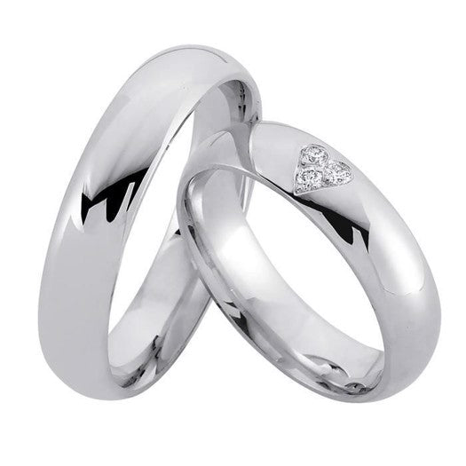 Harmoniske Nuran vielsesringe i rhodineret sterlingsølv med 0,06 ct diamanter i dame- og herreudgave.