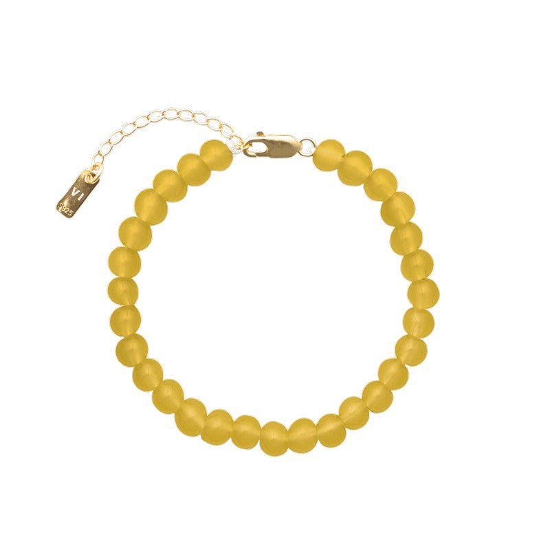 House of Vincent Candy Coral Honey armbånd i justerbart forgyldt sølv med honningfarvede krystalperler 16–19 cm.