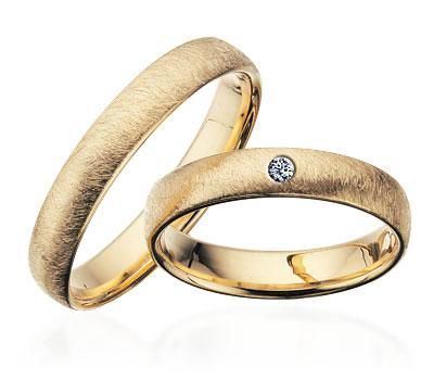 Scrouples vielsesringe i guld med frostet overflade – detalje af fatning med brillant